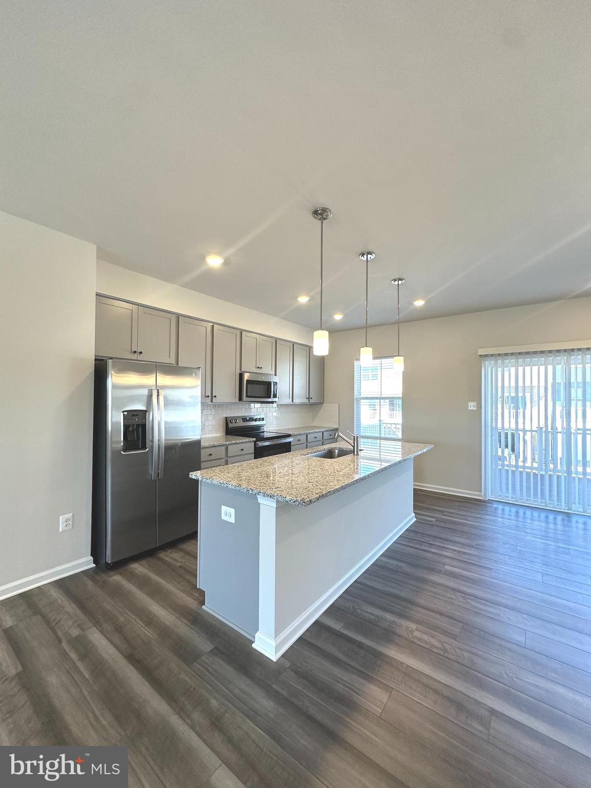 78 Rolling Branch Drive Ranson, WV 25438 - Photo 9 of 49 a large kitchen with stainless steel appliances kitchen island a large counter top and wooden floors