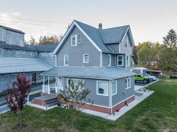 a front view of a house with a yard table and chairs