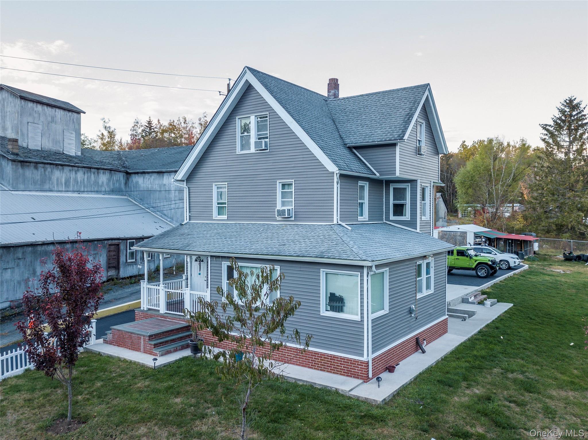 a front view of a house with a yard table and chairs