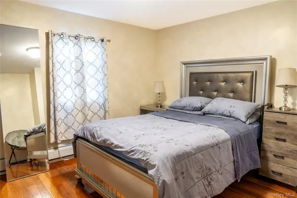 a bedroom with a bed and a mirror