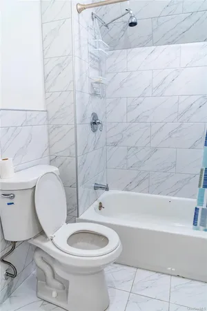 a bathroom with a toilet a sink and bathtub