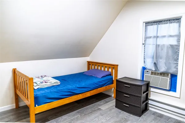 a bed room with a bed and a window