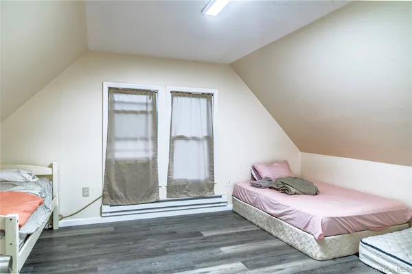 a bedroom with a bed and a mirror