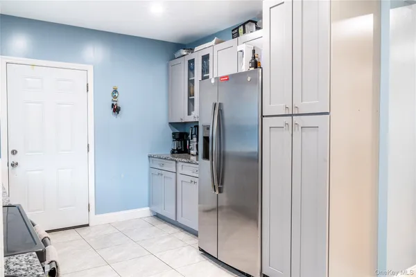 a kitchen with stainless steel appliances granite countertop a refrigerator and a sink