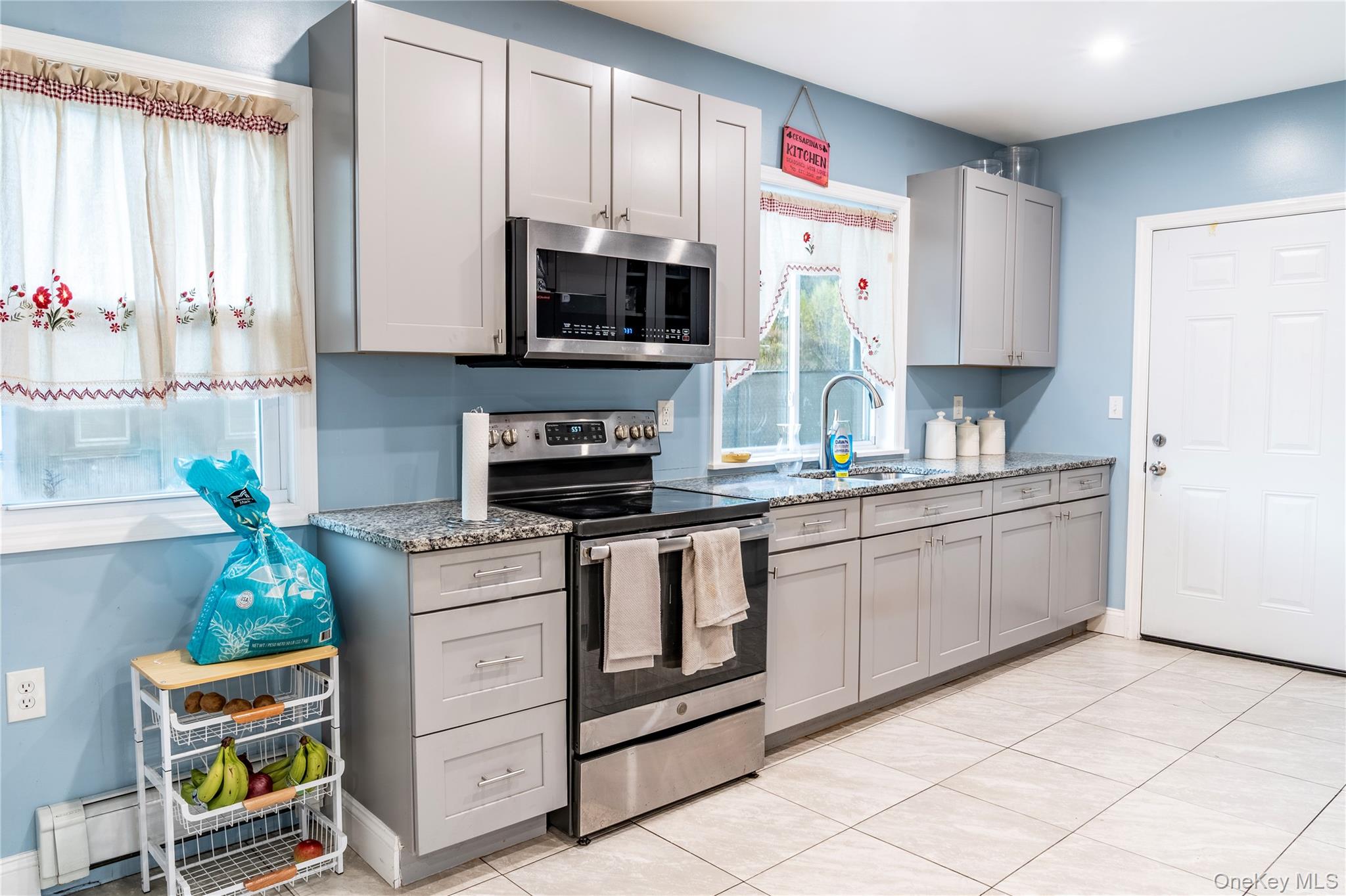 283 Chestnut Street Liberty, NY 12754 - Photo 8 of 22 a kitchen with stainless steel appliances a stove a microwave a sink and cabinets