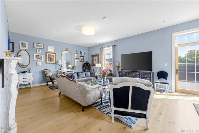 a living room with furniture a flat screen tv and a fireplace