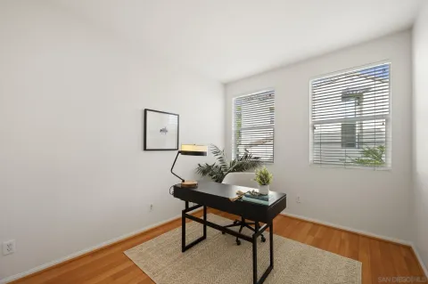 a workspace room with furniture and a window