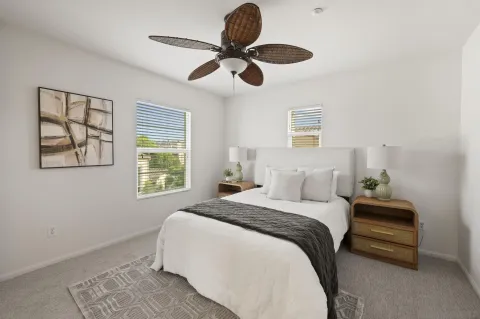 a bedroom with a large bed and a chandelier