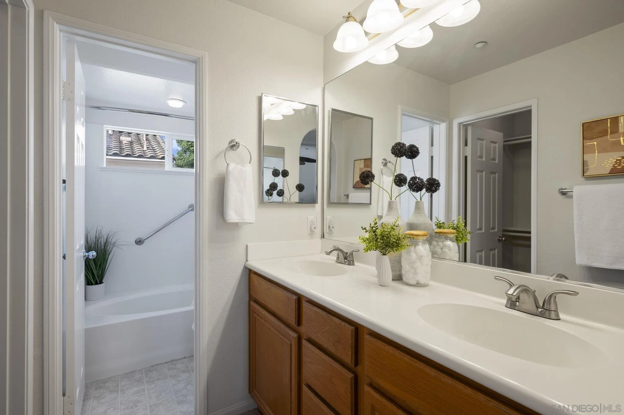 2847 Escala Circle San Diego, CA 92108 - Photo 21 of 35 a bathroom with a bathtub sink and mirror