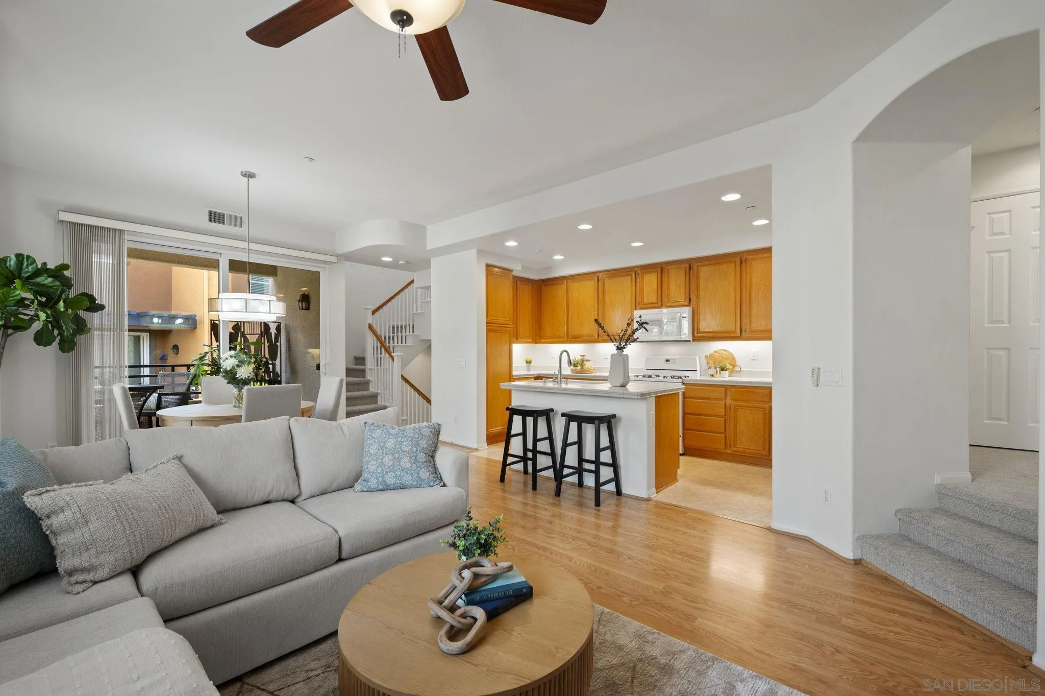 2847 Escala Circle San Diego, CA 92108 - Photo 7 of 35 a living room with furniture kitchen view and a wooden floor