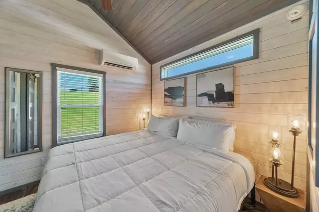 a bedroom with a bed and a window
