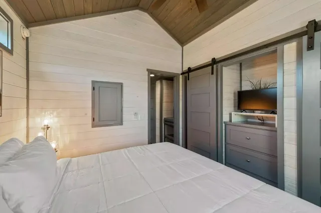 a bedroom with a bed and a chandelier