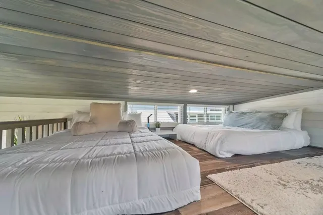 a bedroom with two beds and painted walls