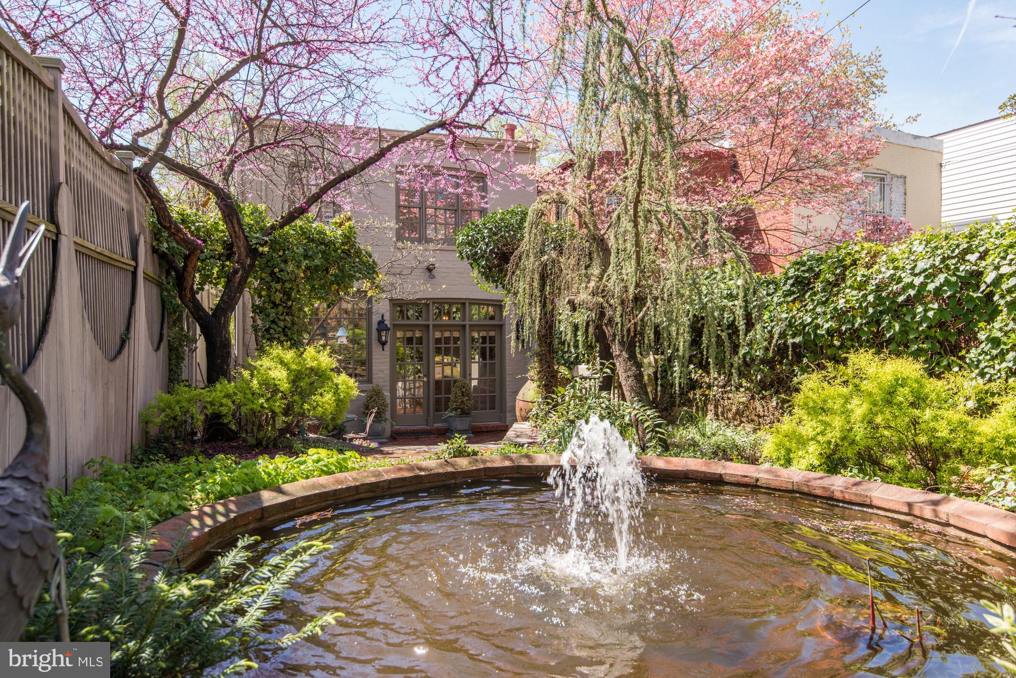 3249 O Street Northwest Washington, DC 20007 - Photo 18 of 24 a wooden bench sitting in front of a building