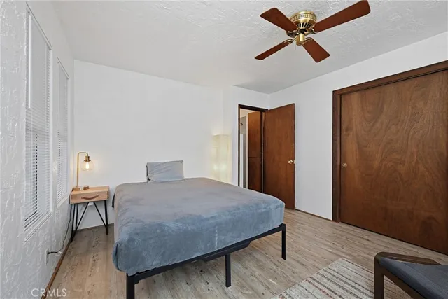 a bedroom with a bed a desk and chair