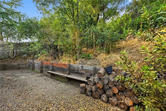 a view of a yard with wooden fence