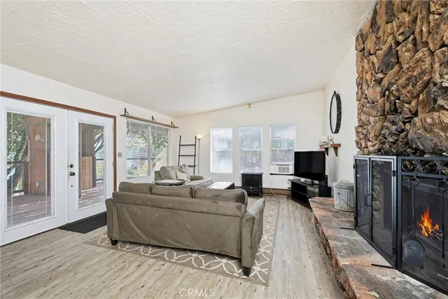 a living room with furniture flat screen tv and a fireplace