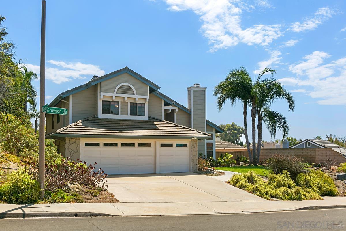 4031 Grayson Drive San Diego, CA 92130 - Photo 2 of 25 a front view of a house with a garden and trees