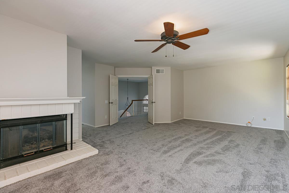 4031 Grayson Drive San Diego, CA 92130 - Photo 17 of 25 a living room with furniture and a fireplace