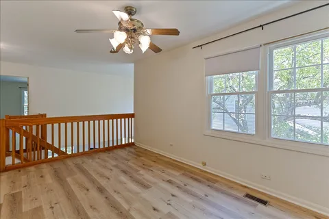 a view of a livingroom with wooden floor and a window