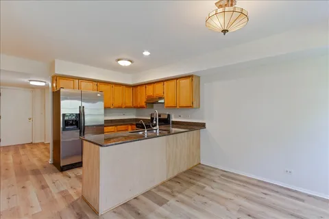a kitchen with stainless steel appliances granite countertop a sink and a stove