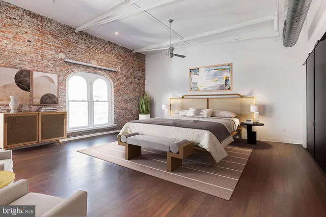 a bedroom with a large bed and a large window