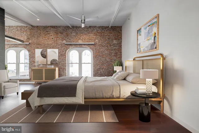 a bedroom with a bed and a large window