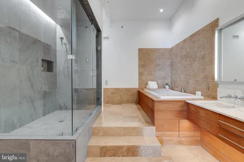 a bathroom with a tub sink and shower
