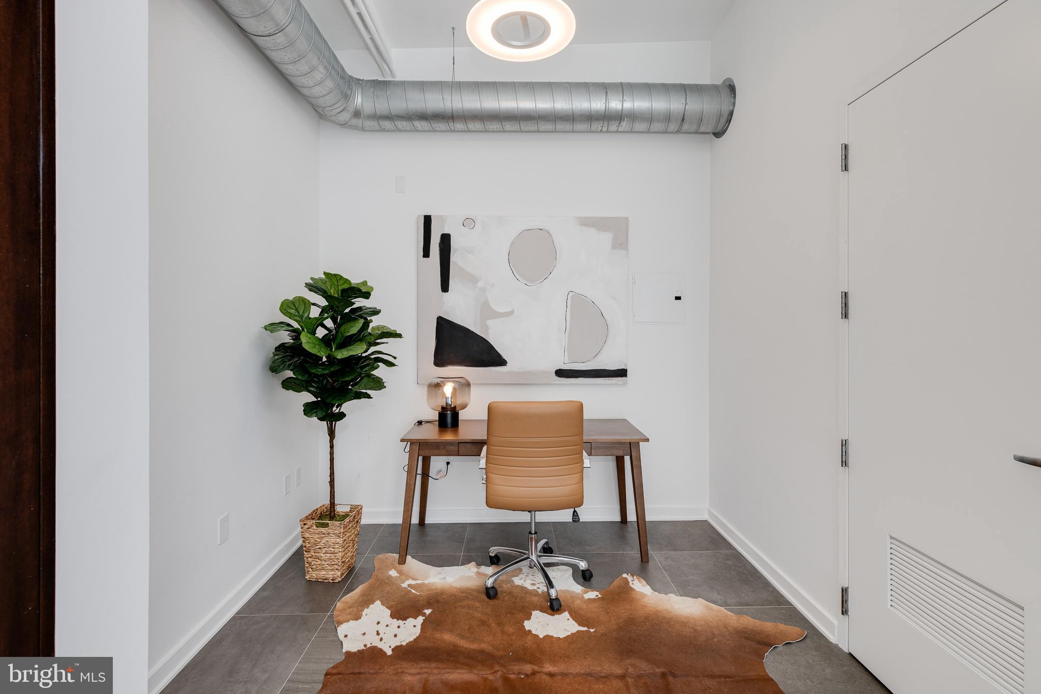 105-32 South 12th Street, Unit PH504 Philadelphia, PA 19107 - Photo 32 of 45 a table with a vase and flowers on it