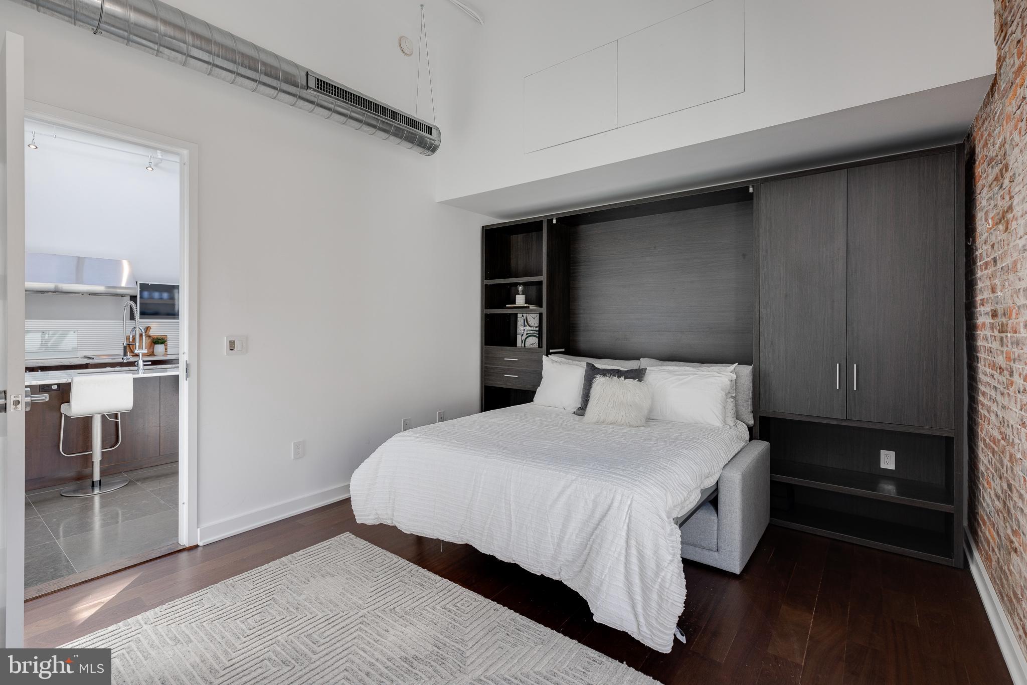 105-32 South 12th Street, Unit PH504 Philadelphia, PA 19107 - Photo 35 of 45 a bedroom with a bed and wooden floor