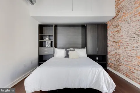 a bedroom with a bed and a night stand