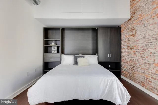 a bedroom with a bed and a night stand