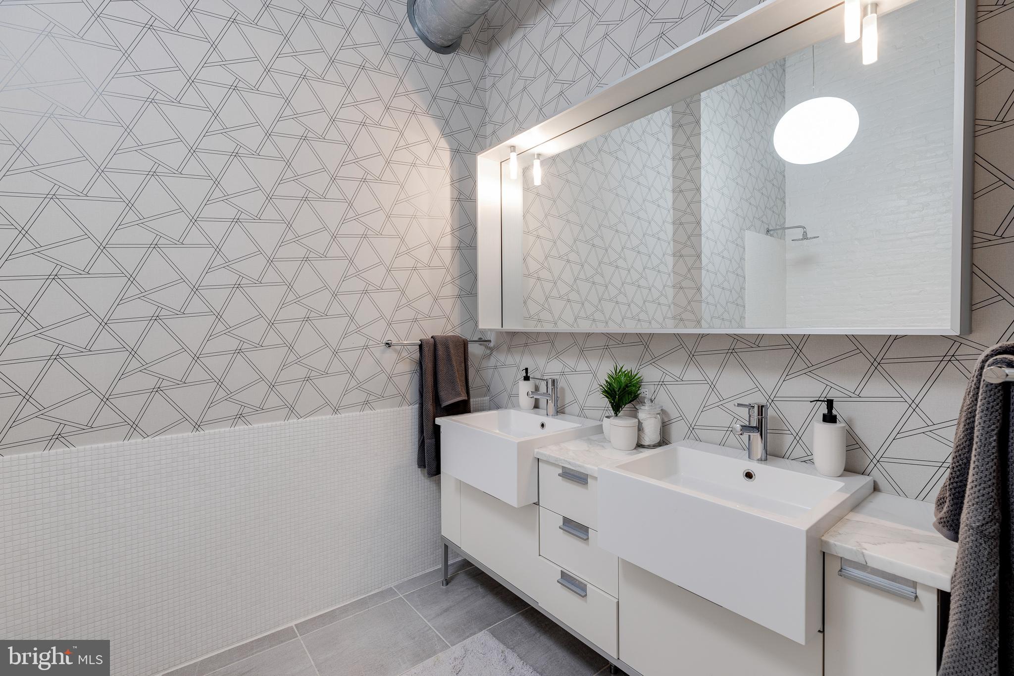 105-32 South 12th Street, Unit PH504 Philadelphia, PA 19107 - Photo 38 of 45 a bathroom with a sink and a mirror