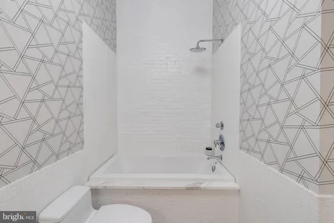 a bathroom with a bathtub and shower