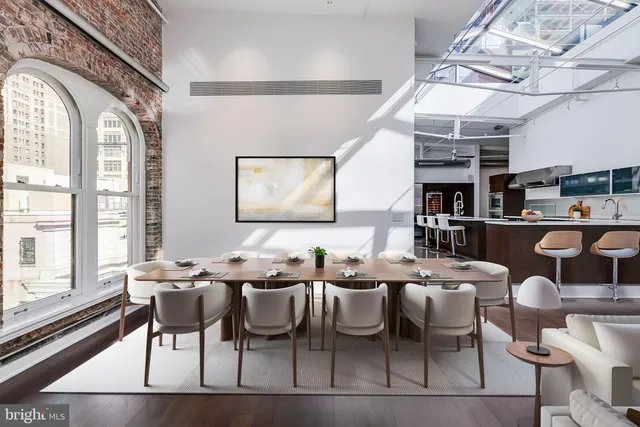 a room with lots of wooden furniture and windows