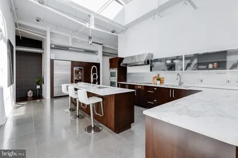 a kitchen with a table chairs sink and cabinets