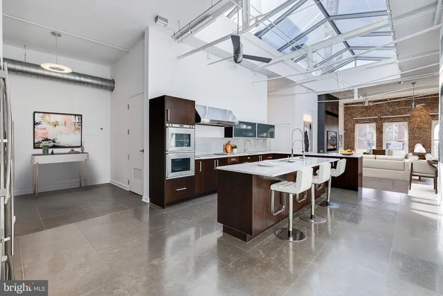 a kitchen with a sink cabinets and window