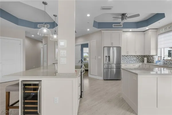 a view of a kitchen with a sink stainless steel appliances and cabinets
