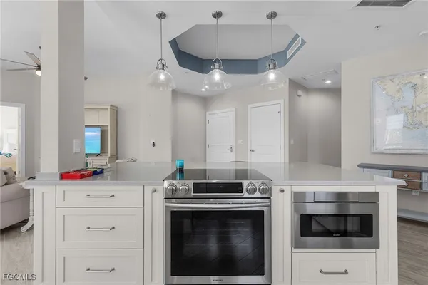 a kitchen with white cabinets and white appliances