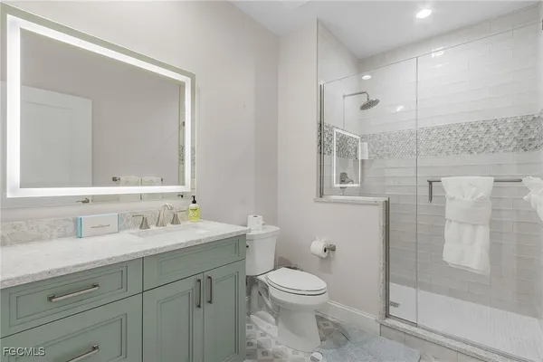 a bathroom with a toilet sink and shower