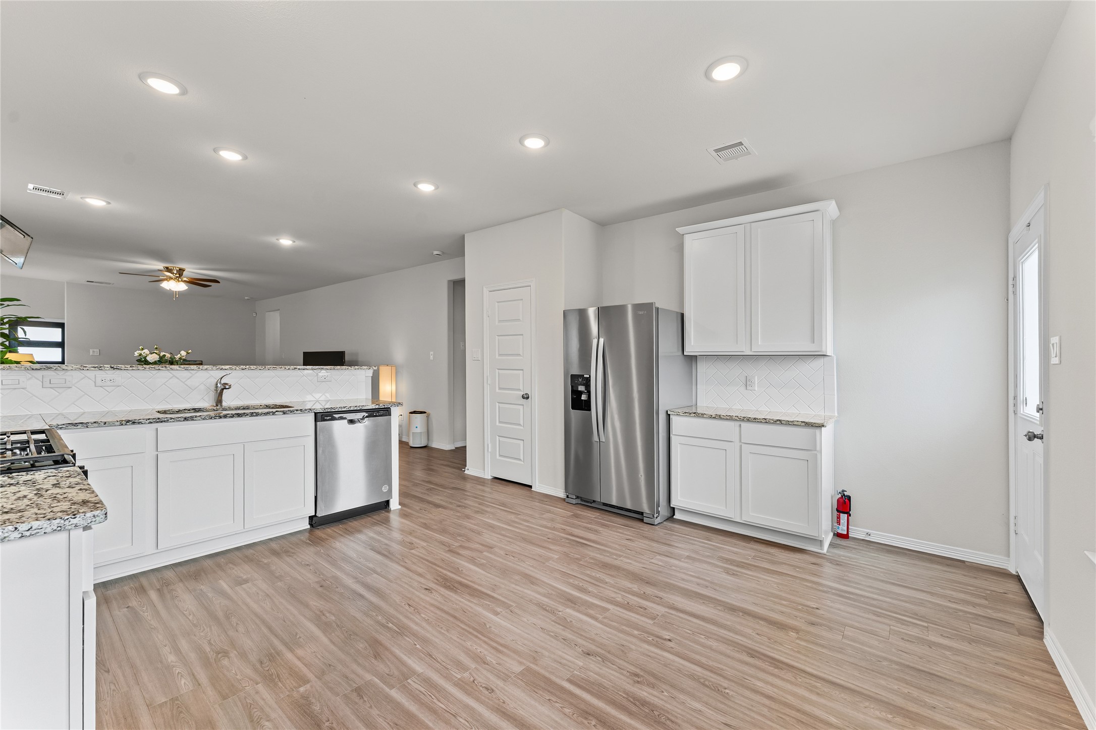 23326 Spring Genesis Lane Katy, TX 77493 - Photo 11 of 32 a large kitchen with stainless steel appliances a refrigerator and a stove top oven