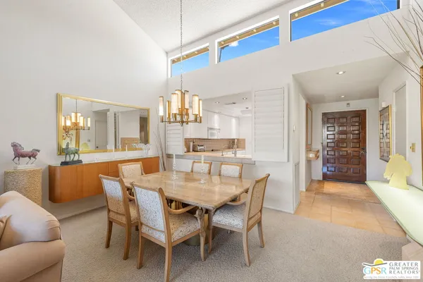 a view of a dining room with furniture large windows and wooden floor
