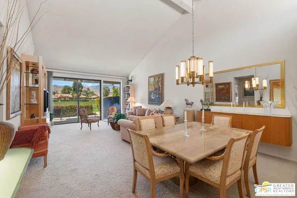 a view of a dining room with furniture large windows and wooden floor
