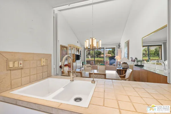 a view of a kitchen with white cabinets