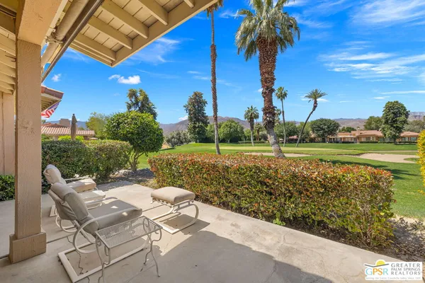 a view of a patio with table and chairs and potted plants