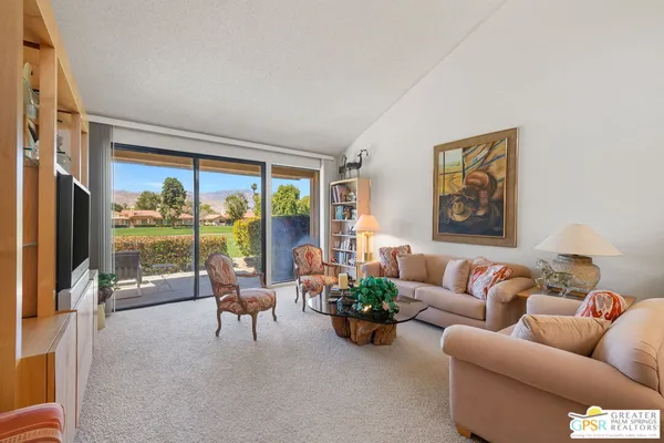 a living room with furniture large window and outer view