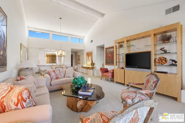 a living room with furniture and a lamp