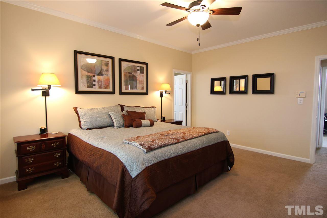5976 Elevation Road Benson, NC 27504 - Photo 11 of 25 a bedroom with a bed and a chandelier