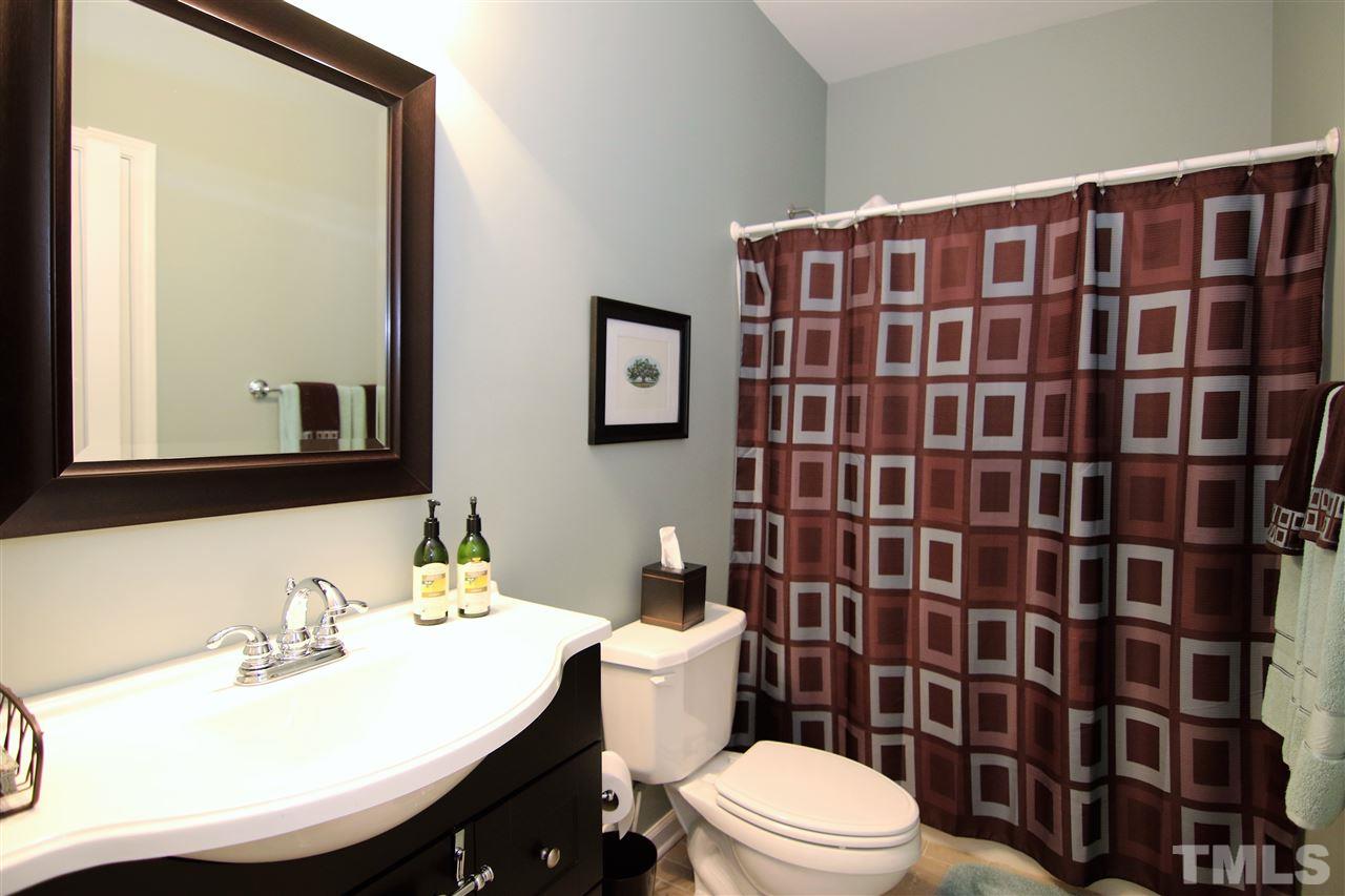 5976 Elevation Road Benson, NC 27504 - Photo 16 of 25 a bathroom with a sink toilet and shower