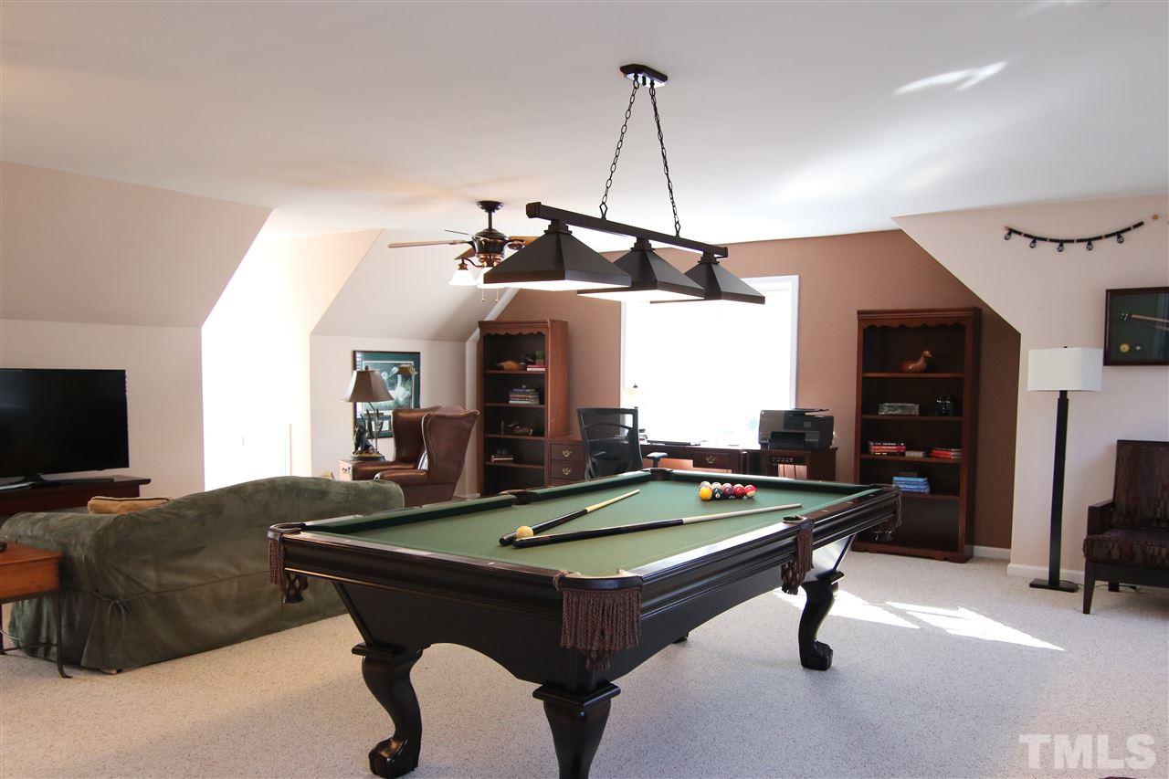 5976 Elevation Road Benson, NC 27504 - Photo 17 of 25 a living room with furniture pool table and a flat screen tv